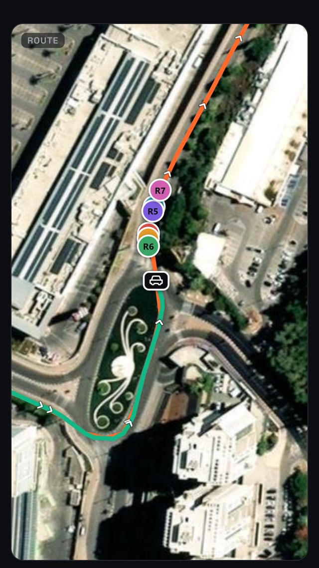 The live map with three riders up the road and the escort car drawn as a car icon behind them