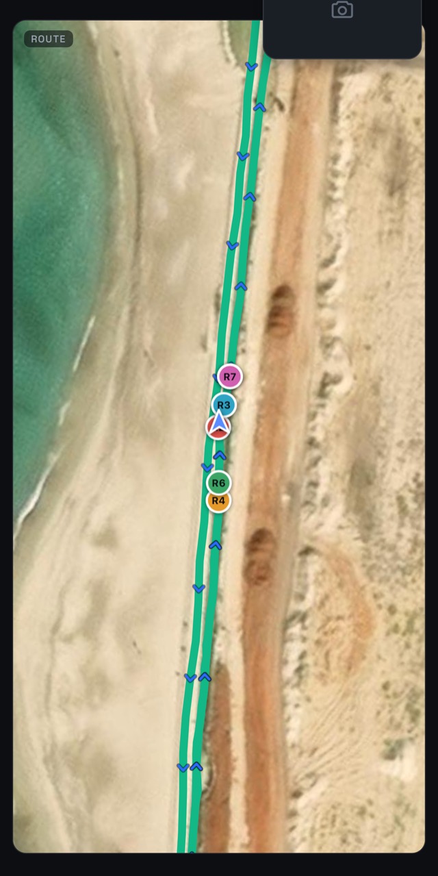 The live map with seven riders spread along the road