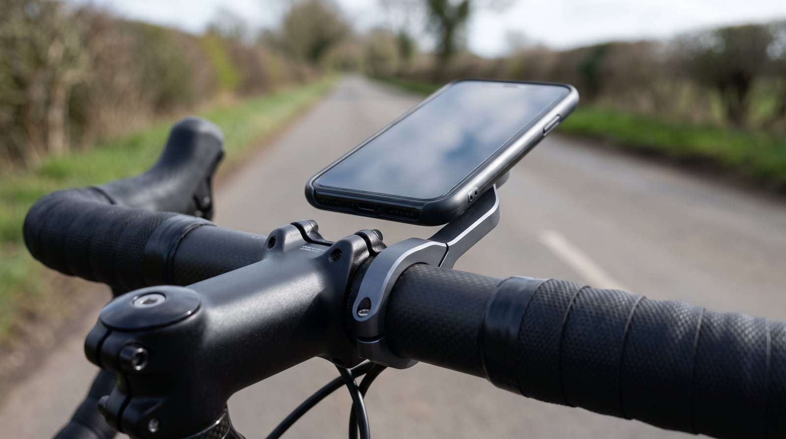 A phone in an out-front mount on road bike handlebars, seen from the rider's position